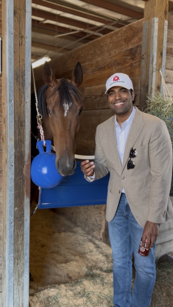 Kevin Sengara, founder of Sengara Racing Media, with a thoroughbred